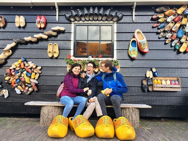 Javier and his assistants sat on a bench outside of a traditional clog shop