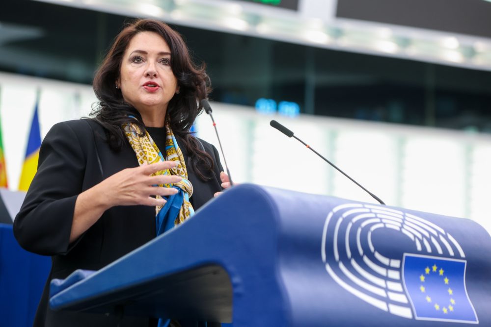 EU Commissioner for Equality Dalli speaks at the podium