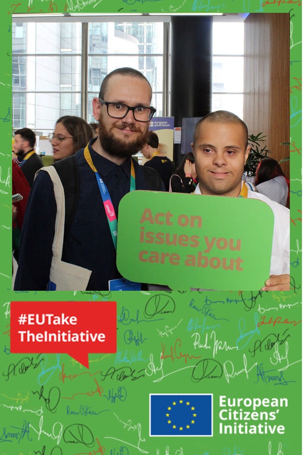Dávid Aranyos (right) and Tibor Czakó (left) posing with a cardboard (in a shape of a speech bubble) with written on it "Act on issues you care about". #EUTakeTheInitiative, logo of the European Citizen Initiative