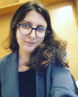 Elisa Marino with glasses and long her taking a selfie of herself