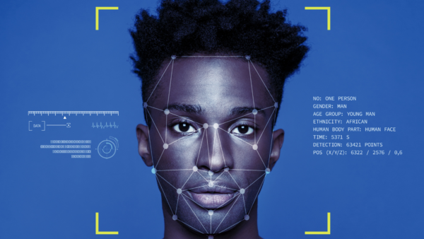 Portrait of a young black man being analysed by a face recognition AI system