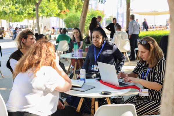 Executive Committee Member Nadia Hada and staff member Giulia Traversi meet with other delegates at the amrgins of the COP