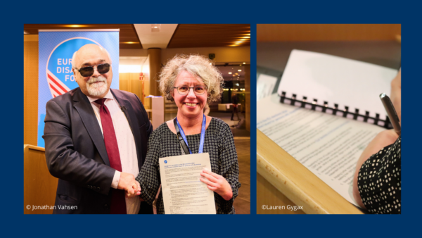 Yannis Vardakastanis (EDF President) and MEP Katrin Langensiepen shaking hands. MEP Katrin Langensiepen is holding EDF's pledge " Building an inclusive future for persons with disabilities" after having signed it