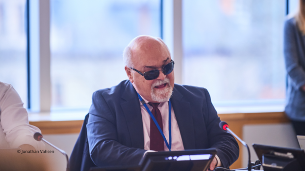 EDF President participating in the Disability Intergroup meeting in January 2024. He is wearing sunglasses and a suit.