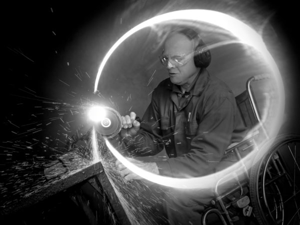 Wheelchair user doing metalwork