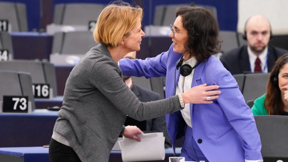 Commissioner Lahbib (on the right) salutes a Mmeber of the European Parliament (blonde woman) with a hug
