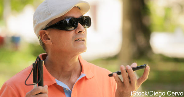 A blind man using the screen reader function on a smartphone