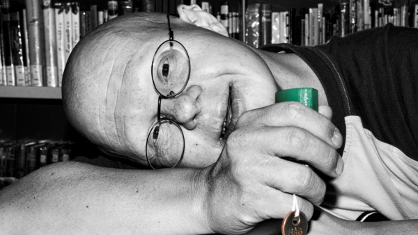 A man with disabilities holding the keys to a house