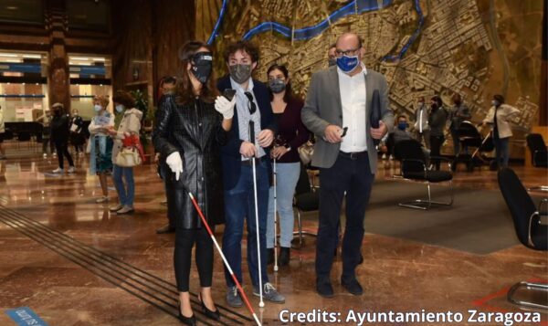 Two blind persons navigate the Zaragoza's City Hall