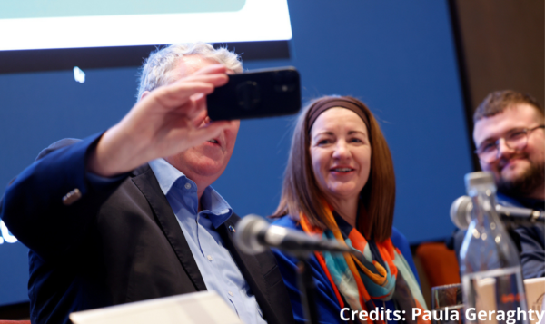 MZP MUlloly takes a photo on podium with Executive Directo of the Disability Federation of Ireland Elaine Teague, and activist Conor Lynnot 